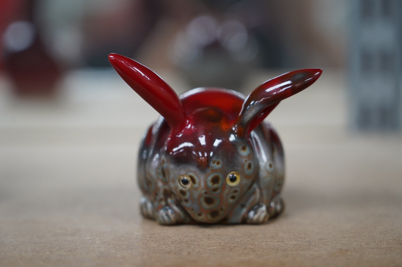 A Bernard Moore grey crystalline glaze rabbit, c.1910, with yellow glass inset eyes, 6cm high. Condition - good